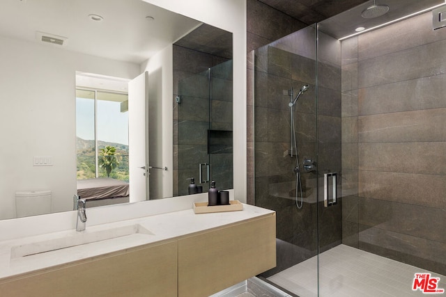 bathroom featuring sink, toilet, and walk in shower