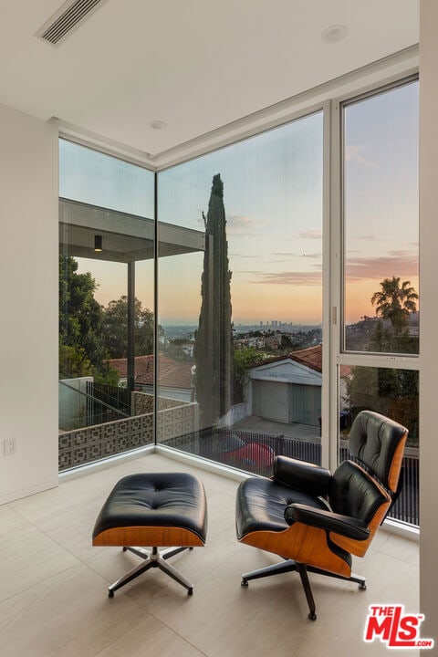 sitting room with floor to ceiling windows and a wealth of natural light