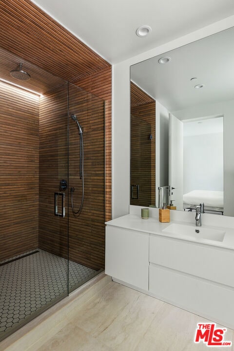 bathroom featuring an enclosed shower and vanity