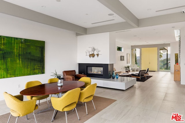 interior space featuring beamed ceiling and a multi sided fireplace