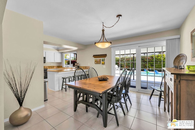 dining area with a healthy amount of sunlight and light tile patterned floors