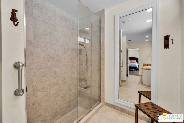 bathroom with tile patterned floors and a tile shower