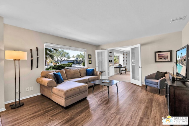 living room featuring dark hardwood / wood-style floors and french doors