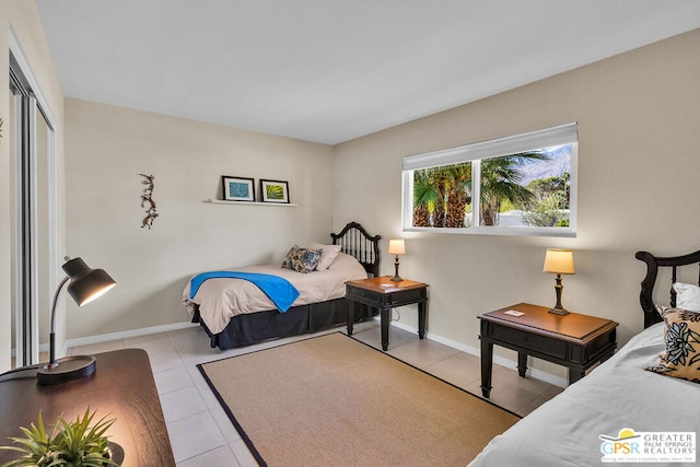 bedroom featuring light tile patterned floors and a closet