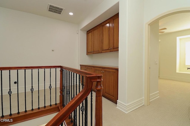 corridor with light colored carpet