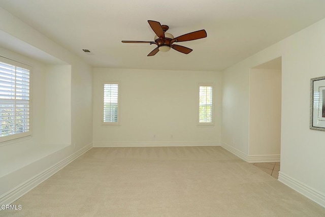 unfurnished room with ceiling fan and light carpet