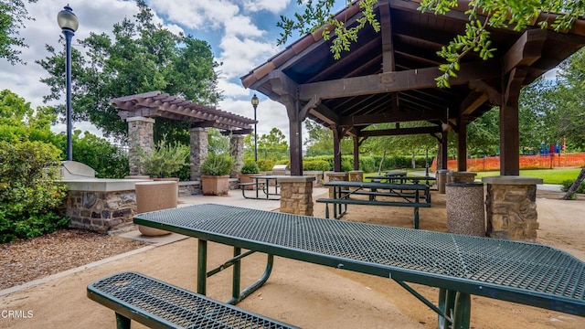 surrounding community with a gazebo, a patio, and an outdoor kitchen