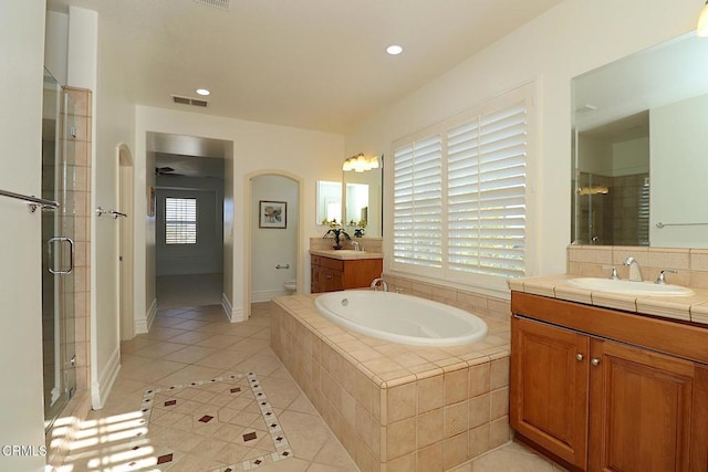 bathroom featuring vanity, separate shower and tub, tile patterned floors, and backsplash