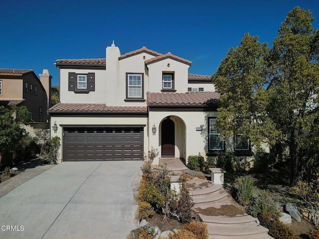 mediterranean / spanish house featuring a garage