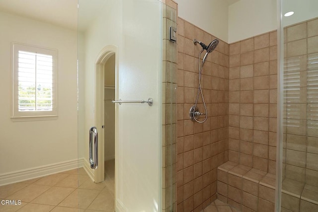 bathroom featuring walk in shower and tile patterned flooring