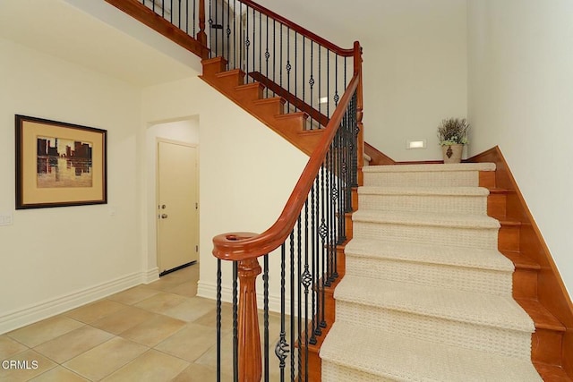 stairs featuring tile patterned flooring