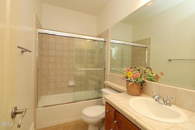 full bathroom featuring vanity, tile patterned floors, enclosed tub / shower combo, and toilet