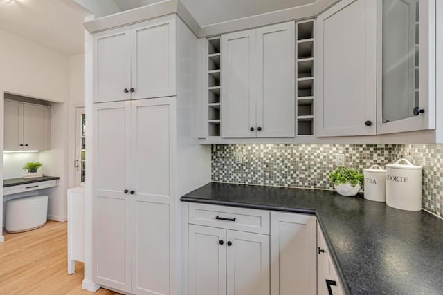 kitchen featuring white cabinetry, backsplash, and light hardwood / wood-style flooring