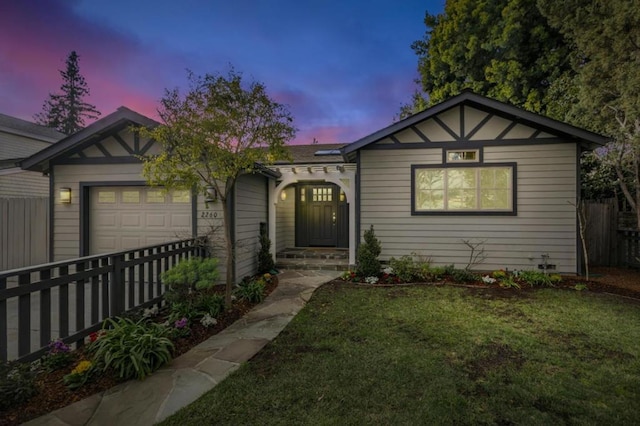 view of front facade featuring a yard and a garage