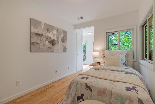 bedroom with hardwood / wood-style flooring