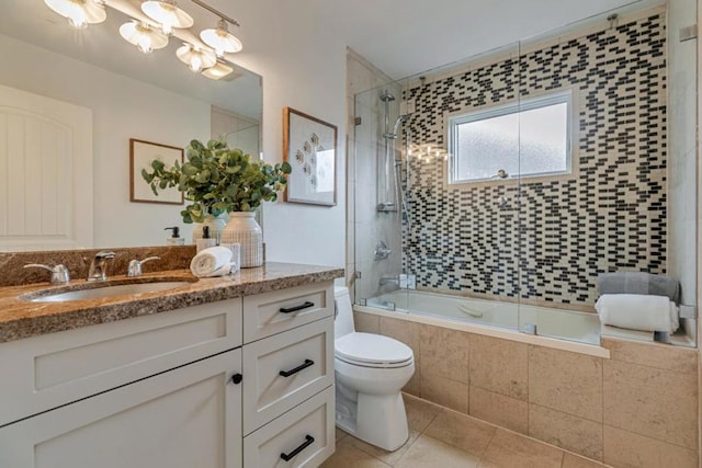 full bathroom with vanity, tile patterned flooring, shower / bath combination with glass door, and toilet