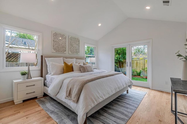 bedroom with multiple windows, access to outside, light hardwood / wood-style floors, and lofted ceiling