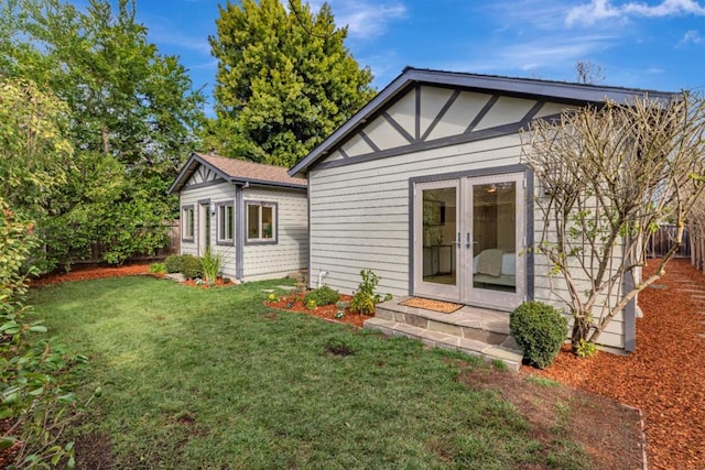 rear view of property with a lawn