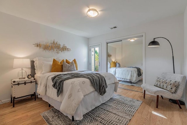 bedroom with hardwood / wood-style floors and a closet