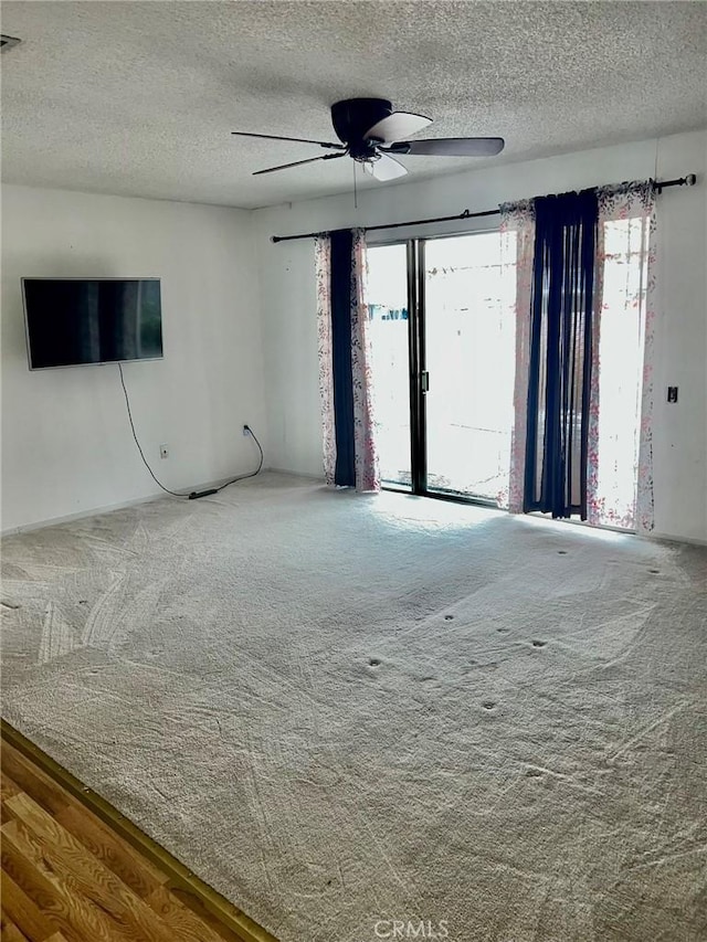 spare room featuring a textured ceiling and carpet flooring