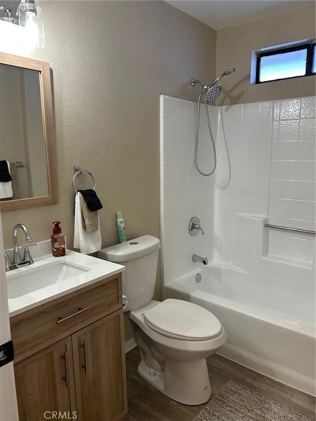 full bathroom featuring shower / bath combination, vanity, wood-type flooring, and toilet