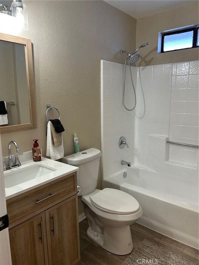 full bath featuring toilet, shower / bathing tub combination, wood finished floors, and vanity