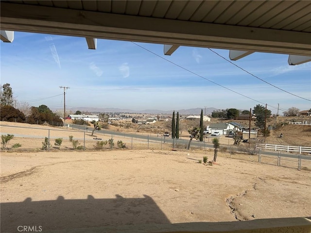 view of yard featuring fence and a rural view