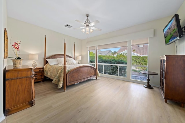 bedroom with light hardwood / wood-style floors and ceiling fan