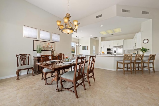 tiled dining space featuring a chandelier and sink