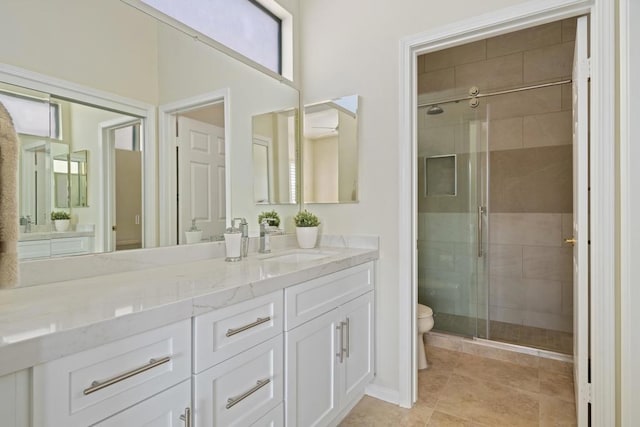 bathroom with vanity, tile patterned floors, toilet, and walk in shower