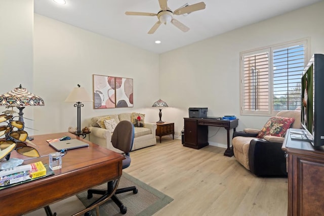 office with ceiling fan and light hardwood / wood-style floors