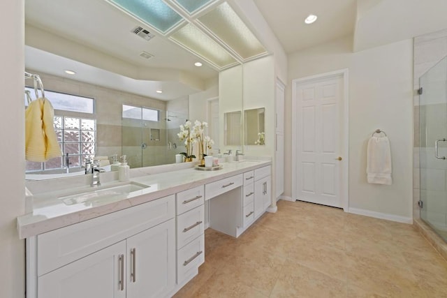 bathroom featuring an enclosed shower and vanity