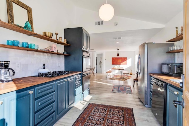 kitchen with pendant lighting, blue cabinetry, wooden counters, backsplash, and black appliances