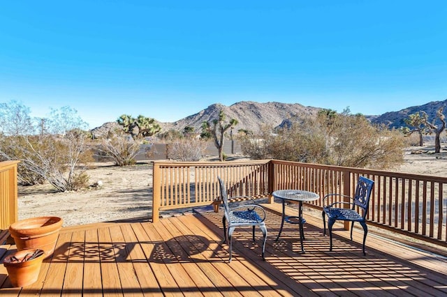 wooden deck with a mountain view