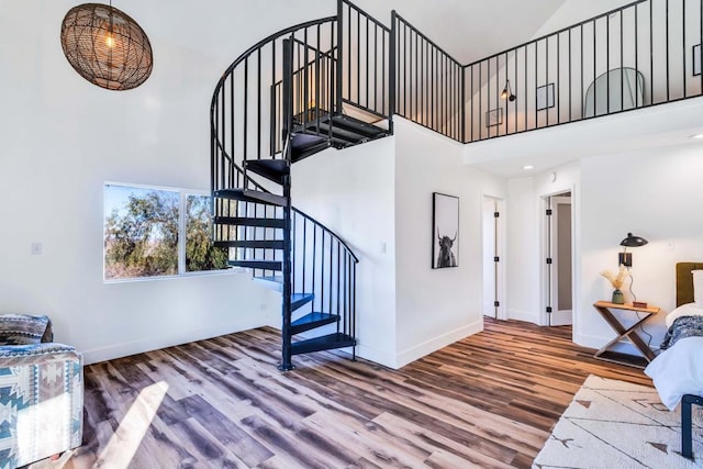 interior space featuring a high ceiling and hardwood / wood-style floors