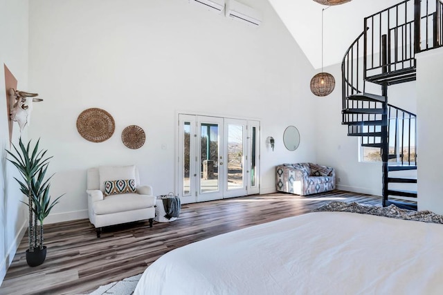 bedroom featuring french doors, high vaulted ceiling, access to exterior, and hardwood / wood-style floors