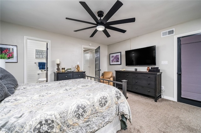 carpeted bedroom with ceiling fan and ensuite bathroom