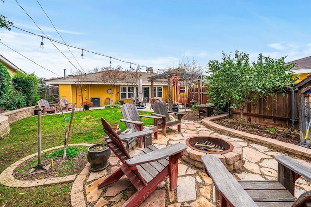 view of patio / terrace with central AC unit and an outdoor fire pit