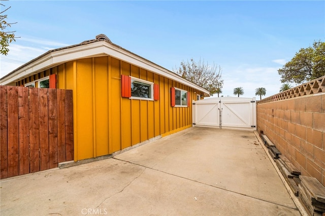 view of side of property with a patio area