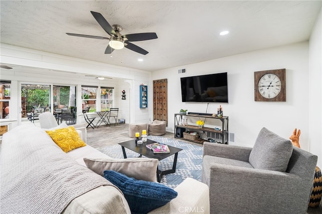 living room with hardwood / wood-style floors and ceiling fan