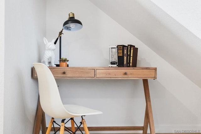 home office with lofted ceiling