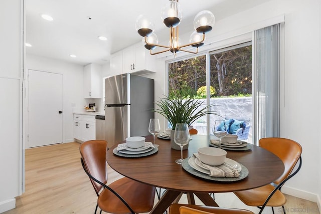 dining room featuring a chandelier and light hardwood / wood-style floors