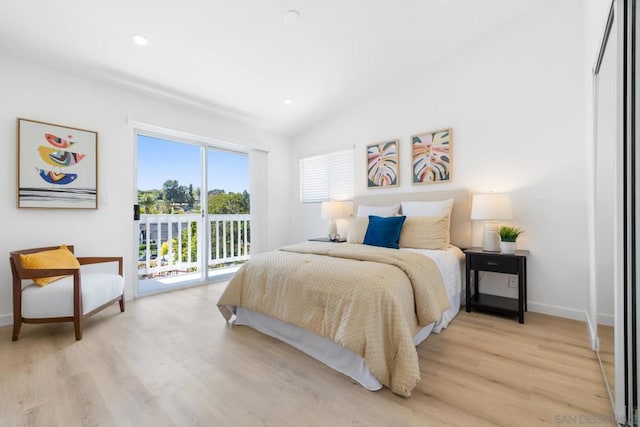 bedroom with lofted ceiling, access to outside, and light hardwood / wood-style floors