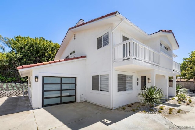 view of front of house with a garage and a balcony