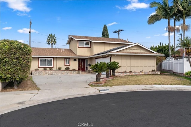 view of property with a garage and a front yard