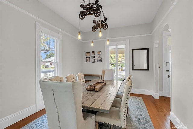 dining area featuring light hardwood / wood-style flooring and a chandelier