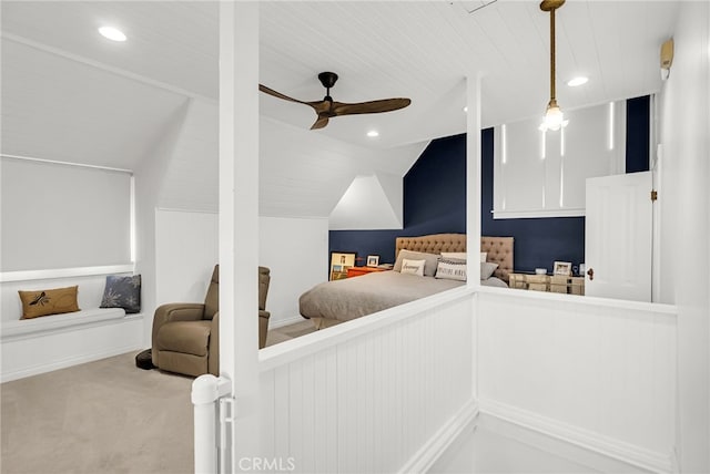 carpeted bedroom with ceiling fan and vaulted ceiling