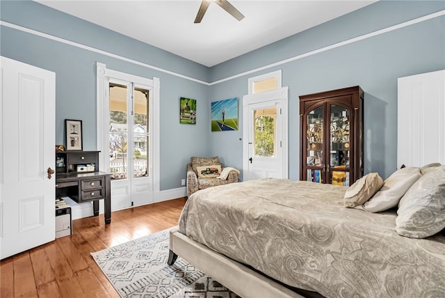 bedroom with hardwood / wood-style flooring, access to exterior, and ceiling fan