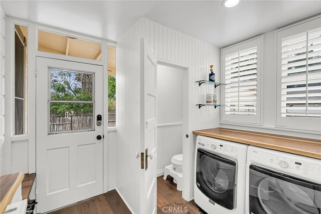 washroom with dark hardwood / wood-style flooring and washer and clothes dryer