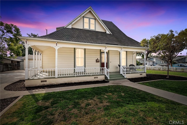 view of front of house featuring covered porch and a lawn